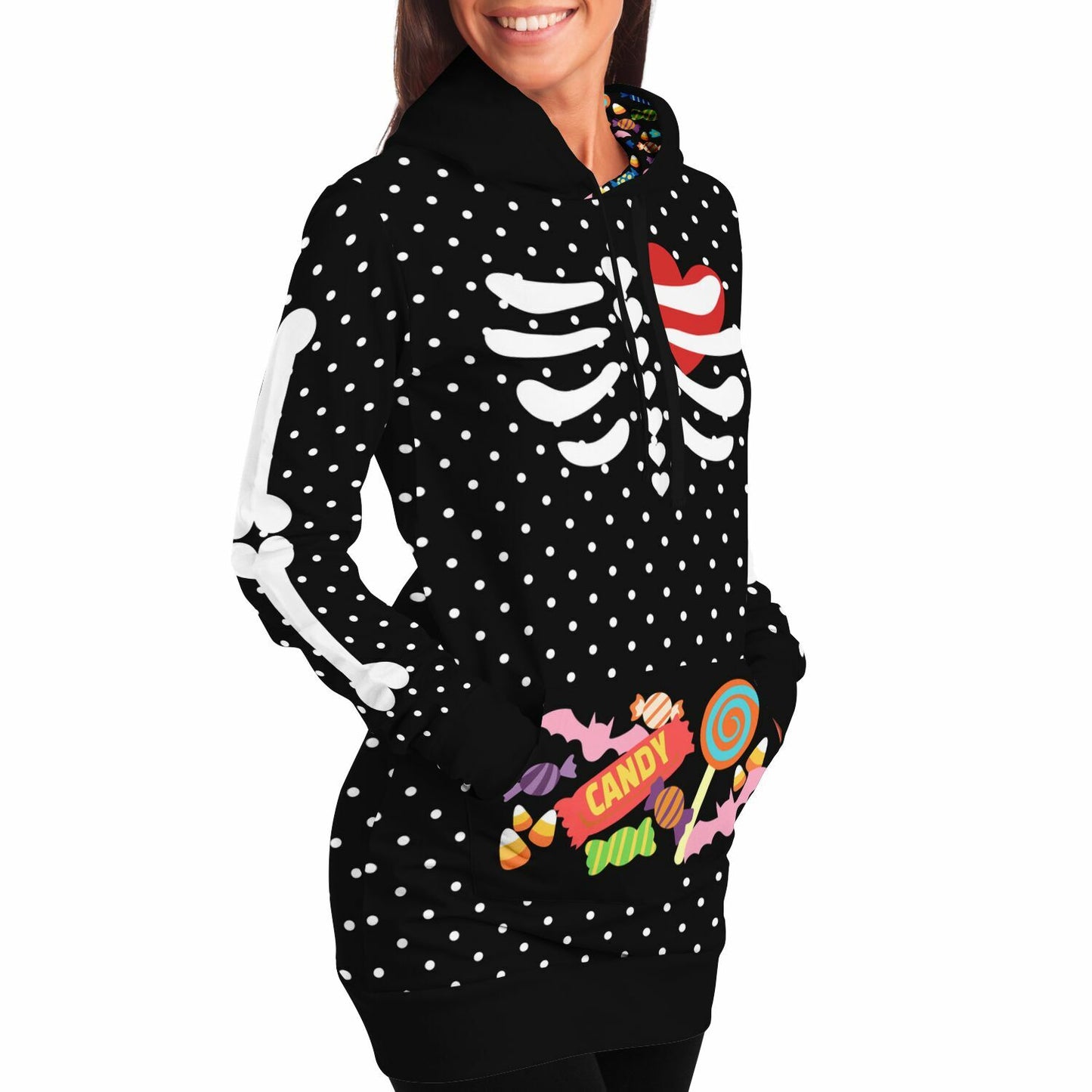 a female model wearing slender style long hoodie hooded sweatshirt, black with white polka dots, a skeleton rib cage and big red heart. Arm bones on the sleeves, candy print on the kangaroo pocket and inside the hood. Flat style hood ties.