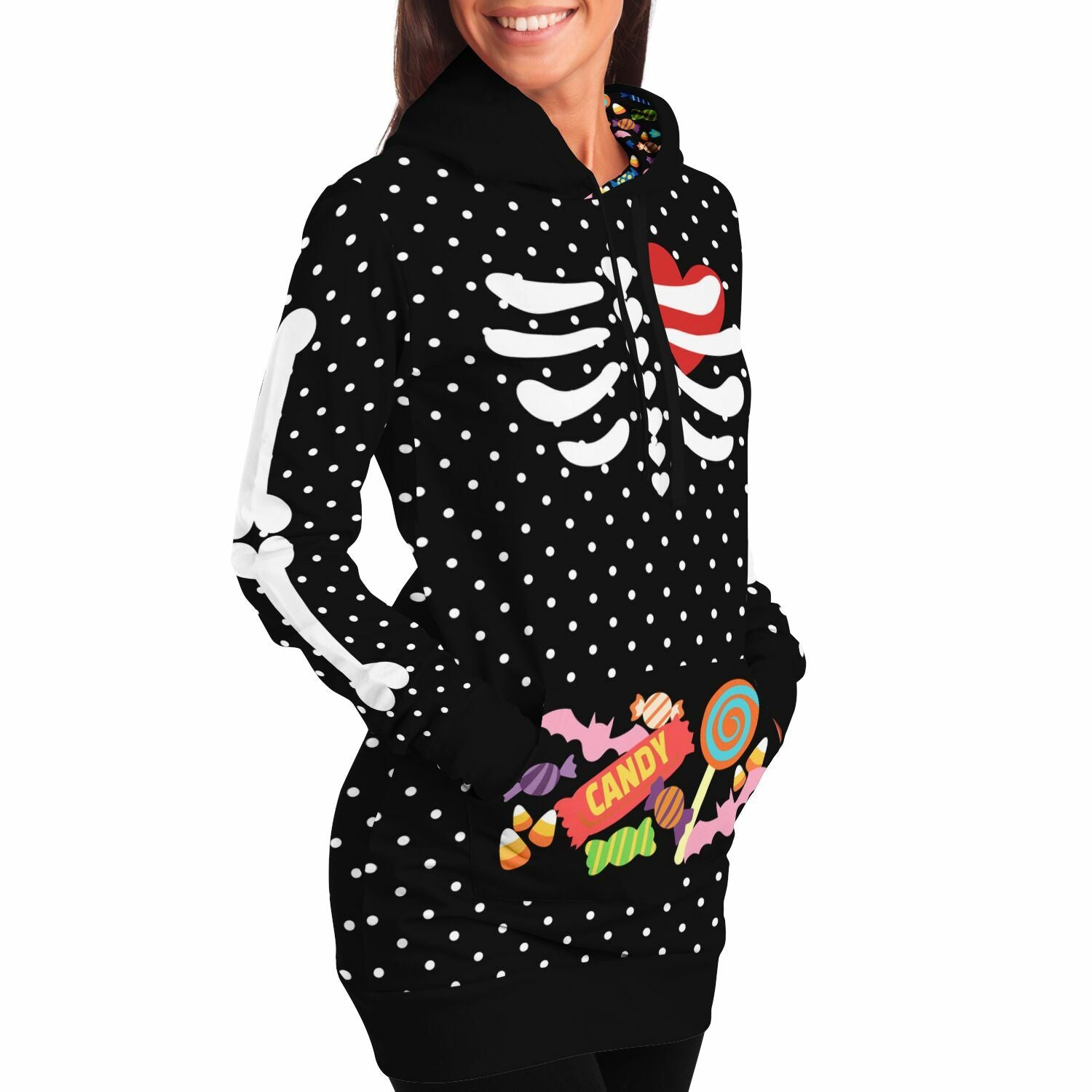 a female model wearing slender style long hoodie hooded sweatshirt, black with white polka dots, a skeleton rib cage and big red heart. Arm bones on the sleeves, candy print on the kangaroo pocket and inside the hood. Flat style hood ties.