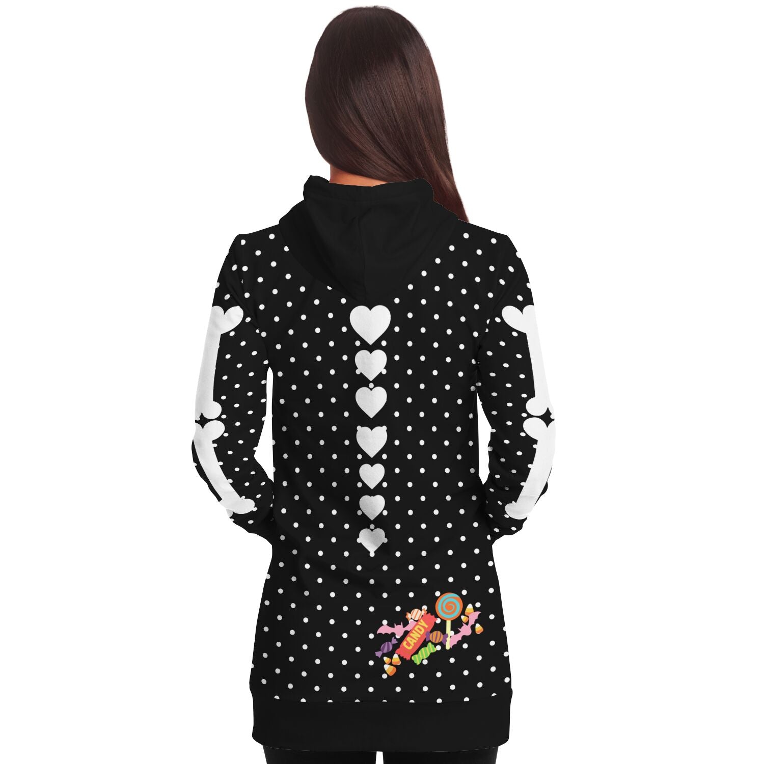 back view of a female model wearing a slender style long hoodie hooded sweatshirt, black with white polka dots, a skeleton rib cage and big red heart. Arm bones on the sleeves, candy print on the bottom rear. 