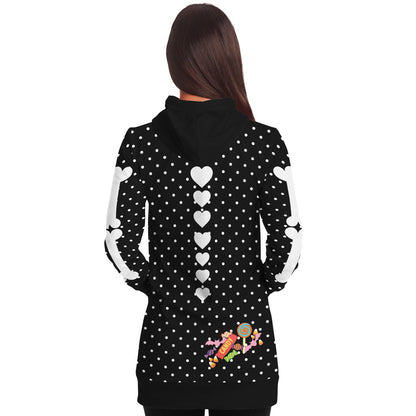back view of a female model wearing a slender style long hoodie hooded sweatshirt, black with white polka dots, a skeleton rib cage and big red heart. Arm bones on the sleeves, candy print on the bottom rear. 