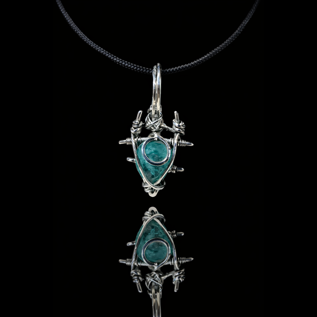 Silver pendant with turquoise stone on a black background